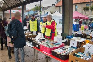 Rotarians at bookstall with boxes of paperbacks